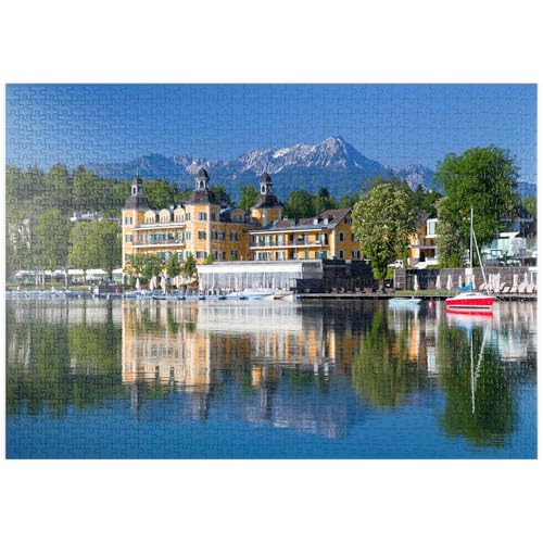 MyPuzzle Schlosshotel am See gegen Mittagskogel (2143m), Velden, Wörther See, Österreich - Premium 1000 Teile Puzzle - MyPuzzle Sonderkollektion von Puzzle Galaxy von MyPuzzle.com